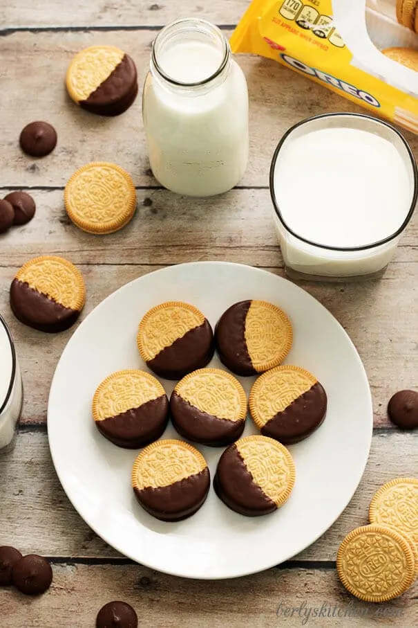 Chocolate dipped Oreos on a white plate.