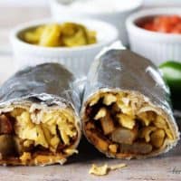 A hearty and filling make ahead breakfast burrito recipe with bacon, eggs, potatoes, and cheese wrapped in a warm tortilla.