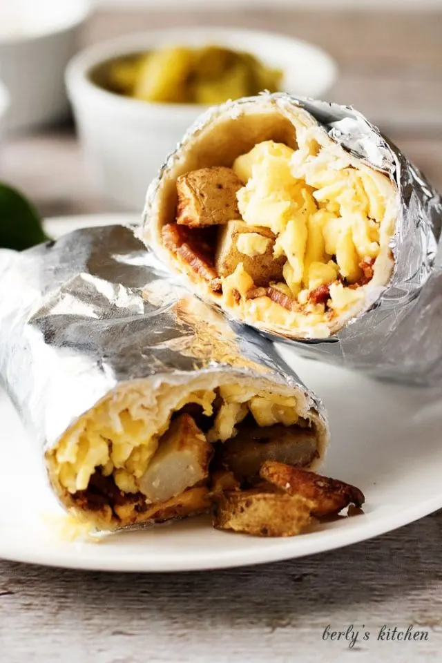A hearty and filling make ahead breakfast burrito recipe with bacon, eggs, potatoes, and cheese wrapped in a warm tortilla.