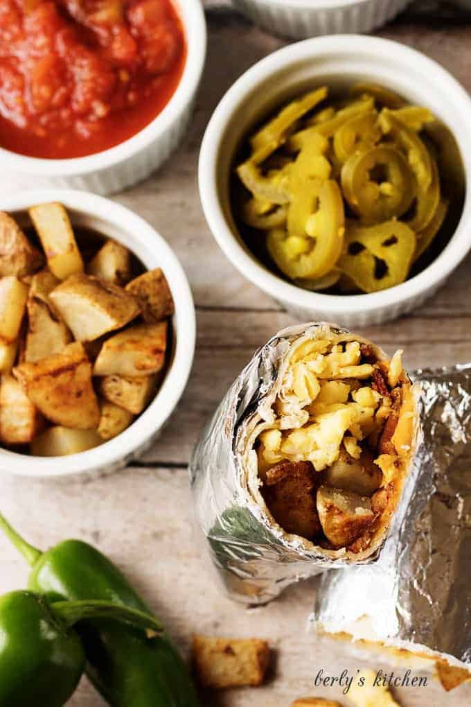 A hearty and filling make ahead breakfast burrito recipe with bacon, eggs, potatoes, and cheese wrapped in a warm tortilla.