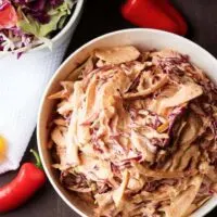 A unique spicy coleslaw recipe made with four ingredients and loaded with flavor. It's simple to prepare and is used to top your favorite sandwich or taco.