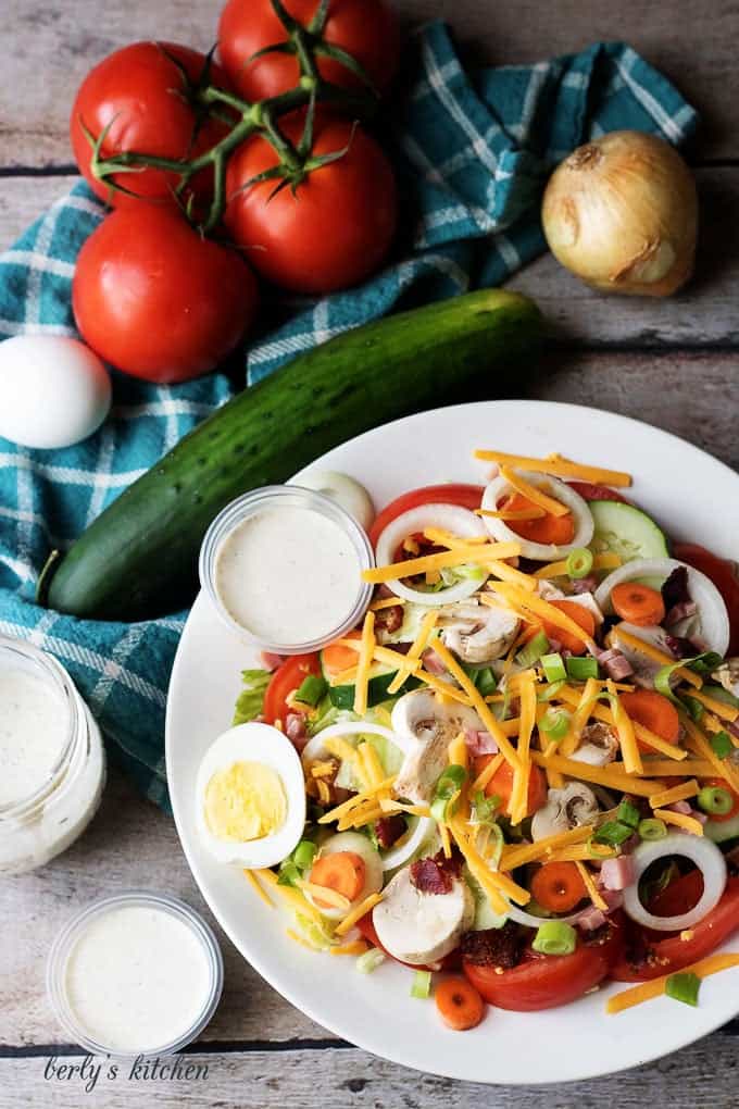 Top down view of chef salad in a large white bowl.