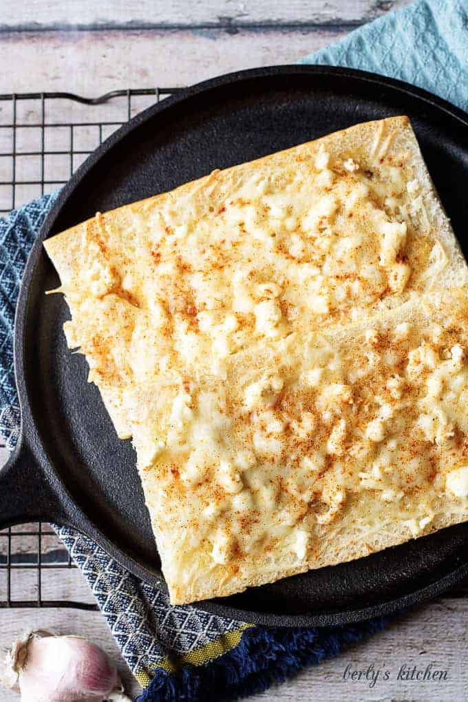 Feta mozzarella topped cheesy bread is the ultimate compliment or starter to any meal. We take Cuban bread, then top with feta, mozzarella, and garlic.