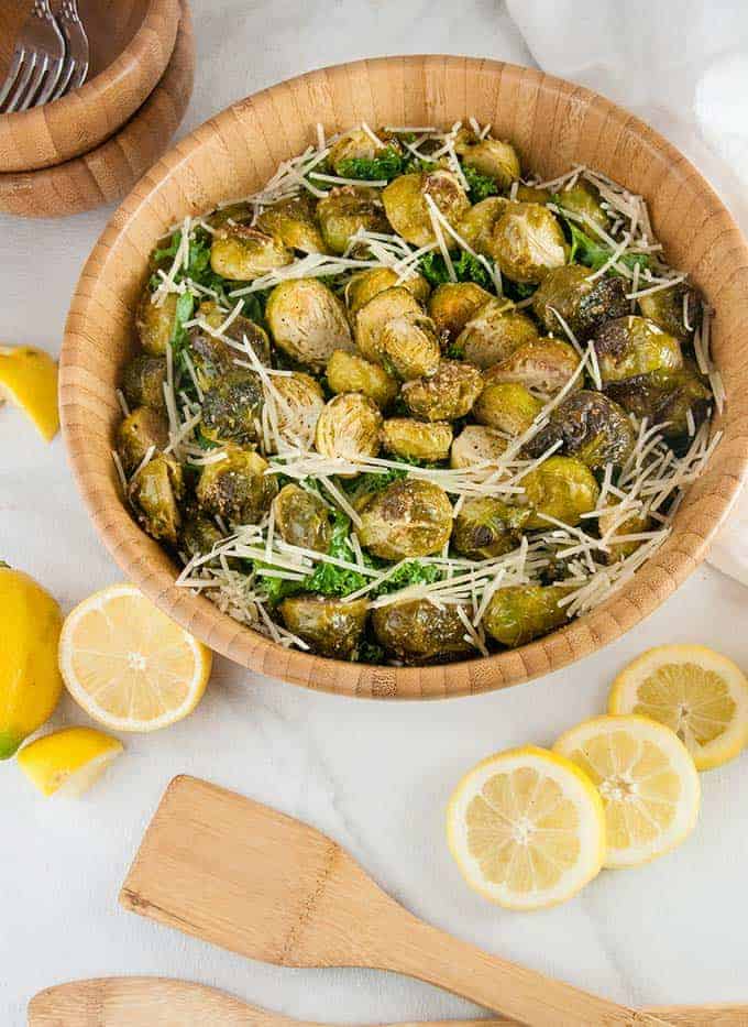 Brussels sprouts Caesar salad in a large wooden bowl.