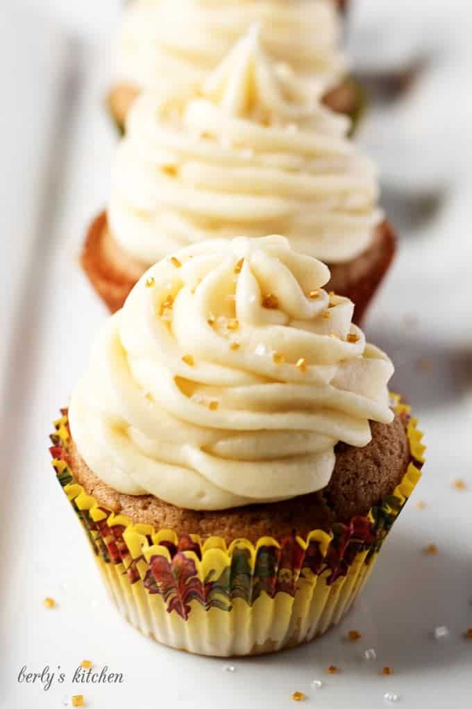 Spiced cupcakes with maple buttercream in a row.