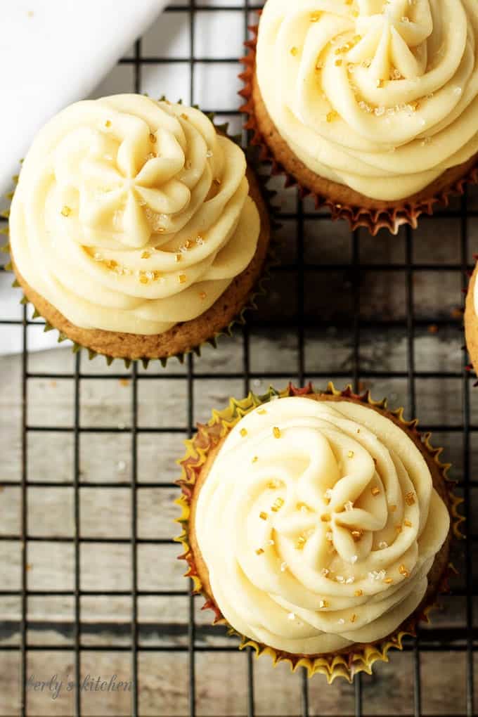 Top down view of spice cupcakes with maple frosting and sprinkles.