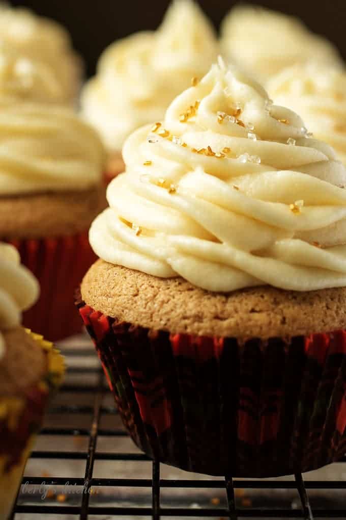 Spiced cupcake in a red and green cupcake liner with maple frosting.