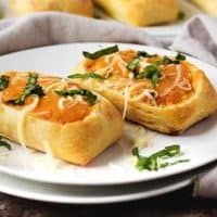 Dinner rolls used as soup bowls with tomato soup.