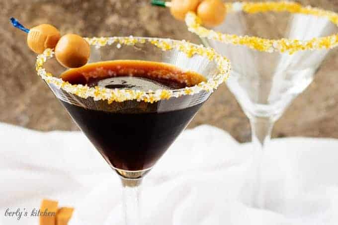 Salted Caramel Coffee Martini with "caramel olives" in a long-stemmed martini glass.