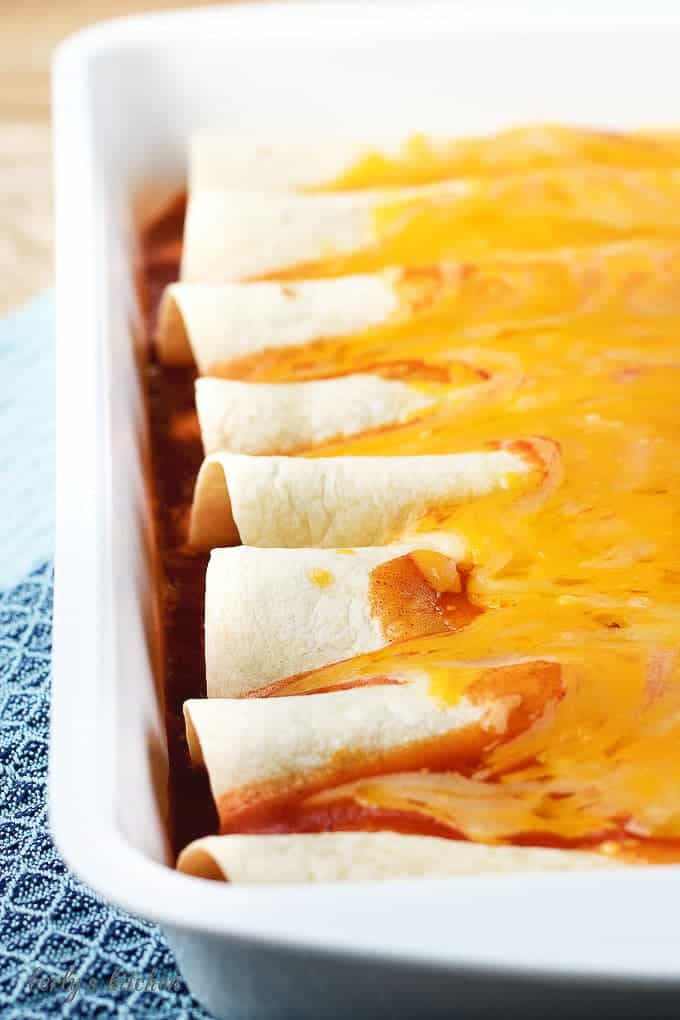 A close-up view of the cooked enchiladas covered in gooey cheese.