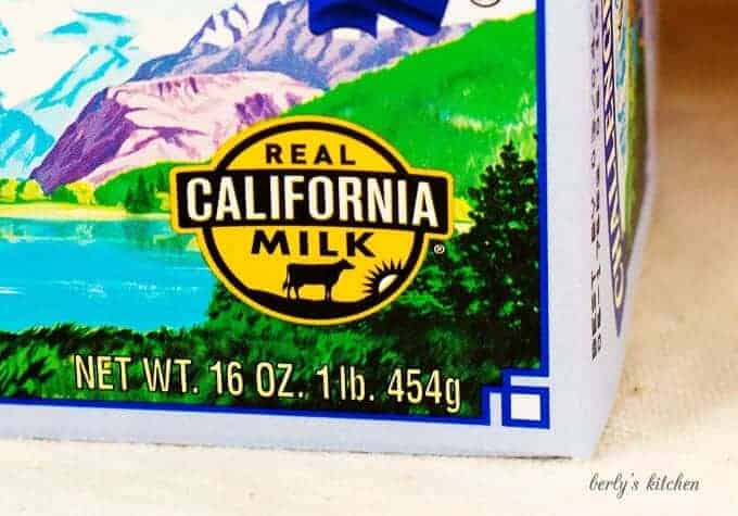 A close-up view of The Real California Milk Seal on a box of butter.