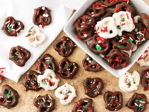 Top-down view of the chocolate covered pretzels recipe , white and dark chocolate dipped pretzels with sprinkles.
