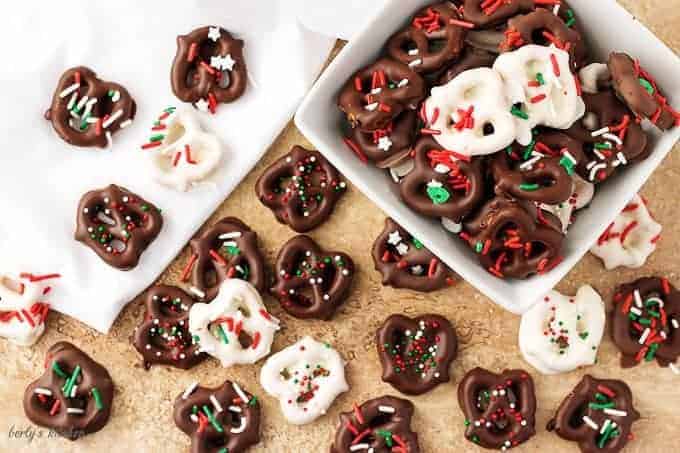 Top-down view of the chocolate covered pretzels recipe , white and dark chocolate dipped pretzels with sprinkles.