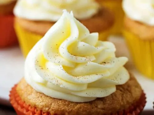 A side-view of the finished eggnog cupcakes, with buttercream frosting ready for serving.