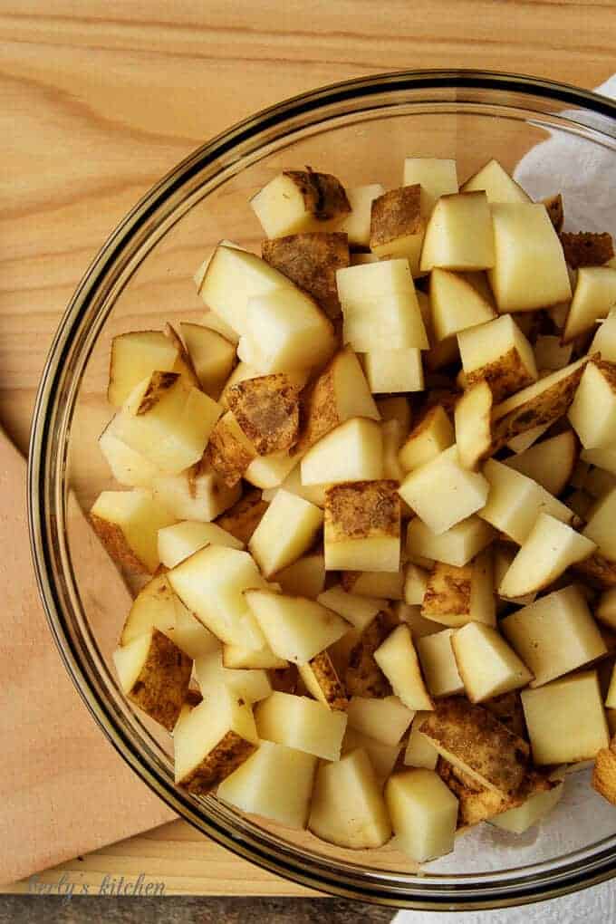 The diced potatoes in a large mixing bowl ready to be tossed with oil.