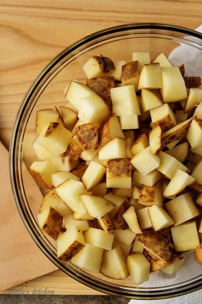 The diced potatoes in a large mixing bowl ready to be tossed with oil.