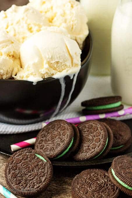 All the ingredients like mint oreo cookies, milk, and ice cream on a table.