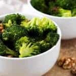 A close-up picture of the finished oven roasted broccoli separated into two serving bowls.