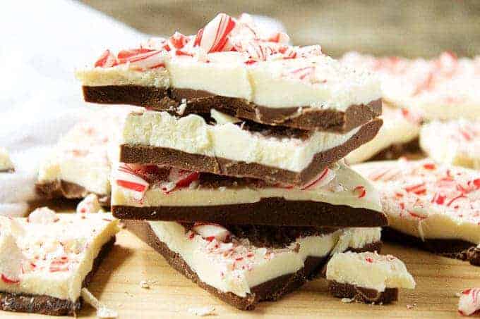 A close-up view of the peppermint bark pieces, stacked up on a cutting board.