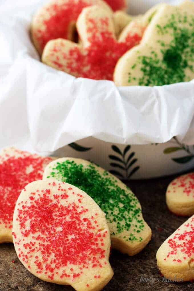 The cooked sugar cookies, sprinkled with colorful sugar placed in a cookie tin.