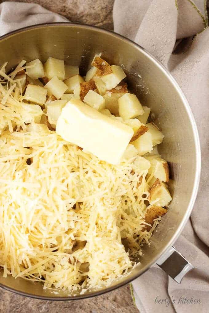 Top-down photo of the cooked potatoes in a mixing bowl with rest of the ingredients.