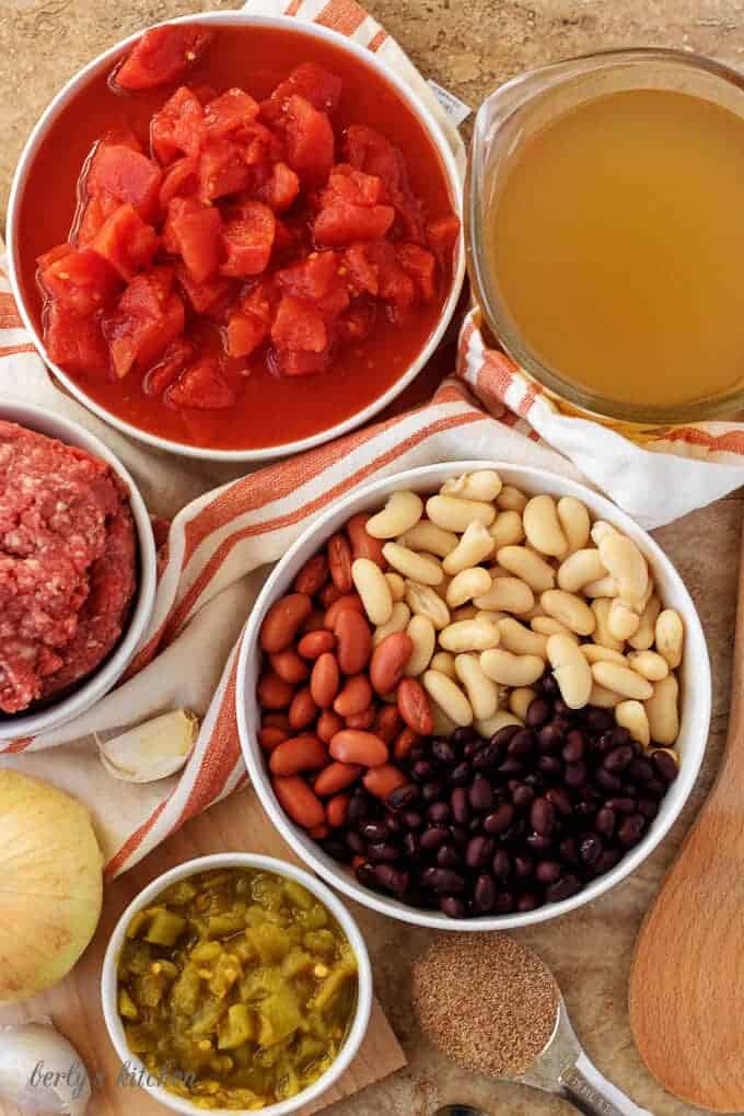 An aerial photo of the ingredients like, ground beef, beans, diced tomatoes, and garlic.