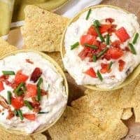 An aerial photo of the finished blt dip garnished with diced tomatoes and green onions.