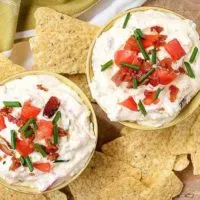 An aerial photo of the finished blt dip garnished with diced tomatoes and green onions.