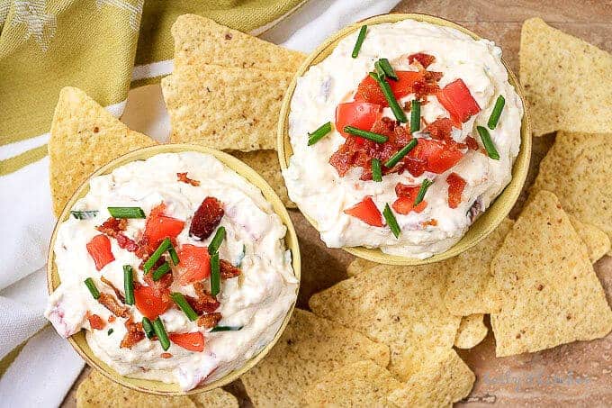 An aerial photo of the finished blt dip garnished with diced tomatoes and green onions.