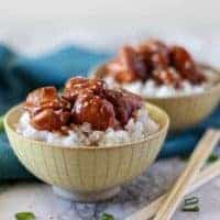 The finished mongolian chicken in yellow bowls served over white rice.