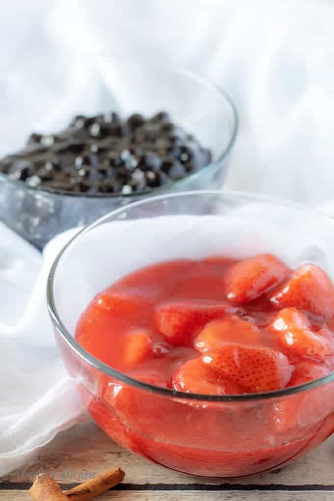 A picture displaying the completed blueberry and strawberry toppings in clear glass bowls.