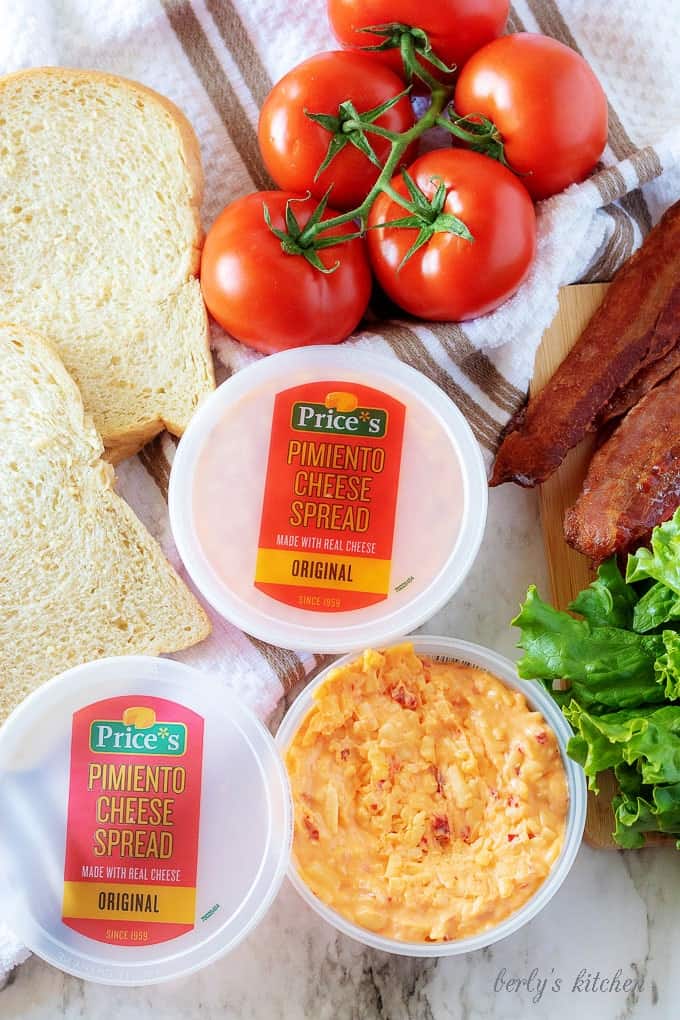 An aerial photo of the ingredients like cooked maple bacon, vine-ripe tomatoes, and sourdough bread.