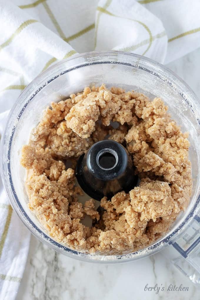 An aerial view of the crisp topping in the food processor after it has been mixed.