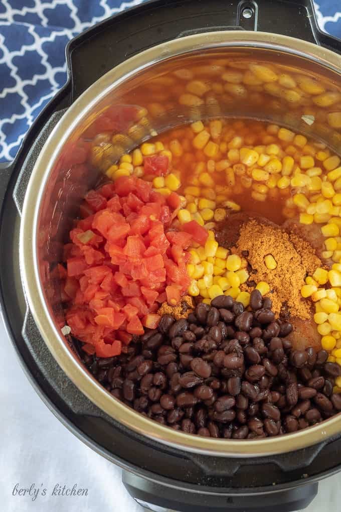 An aerial photo of the chicken taco soup ingredients put into the instant pot, ready to be sealed and cooked.