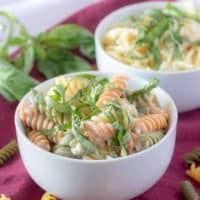 A final photo of the finished lemon cream sauce mixed with cooked pasta and garnished with fresh basil.