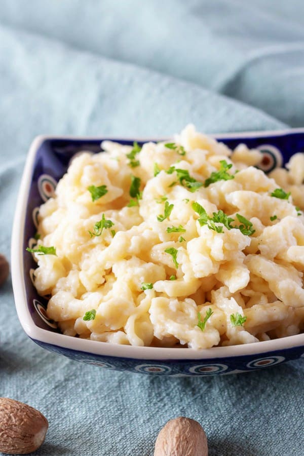 A large picture showing the spaetzle recipe garnished with parsley and ground nutmeg.