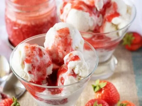 The final picture of the finished strawberry sauce drizzled over vanilla ice cream.