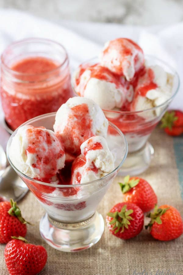 The four ingredient strawberry sauce poured over two martini glasses filled with vanilla ice cream.