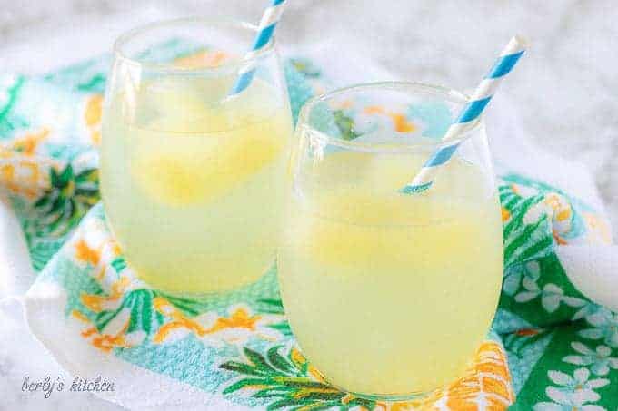 The finished tropical cocktail booze cubes, served with blue straws. As the cubes melt the water looks like lemonade.