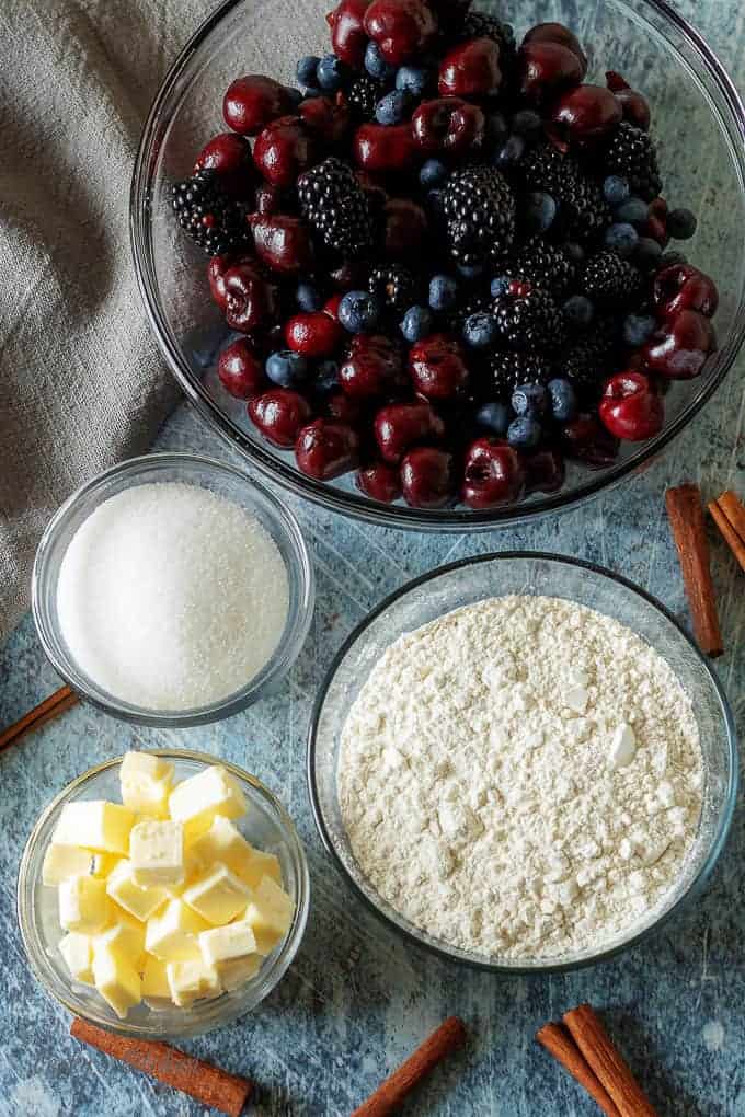 A top-down photo of the sugar, berries, butter, and flour.