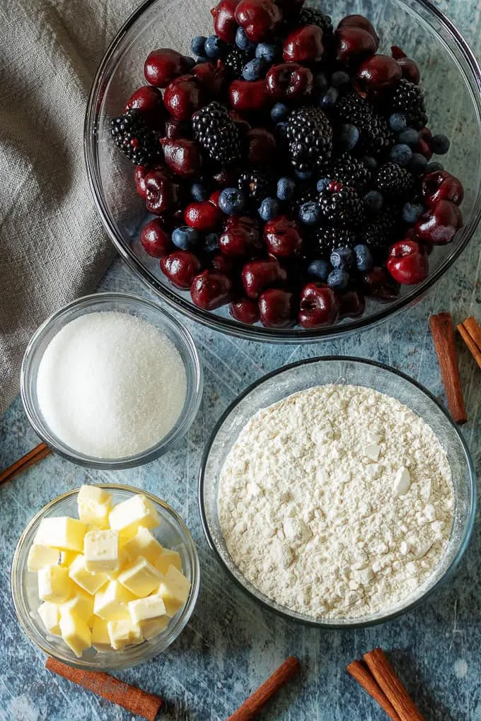 A top-down photo of the sugar, berries, butter, and flour. 