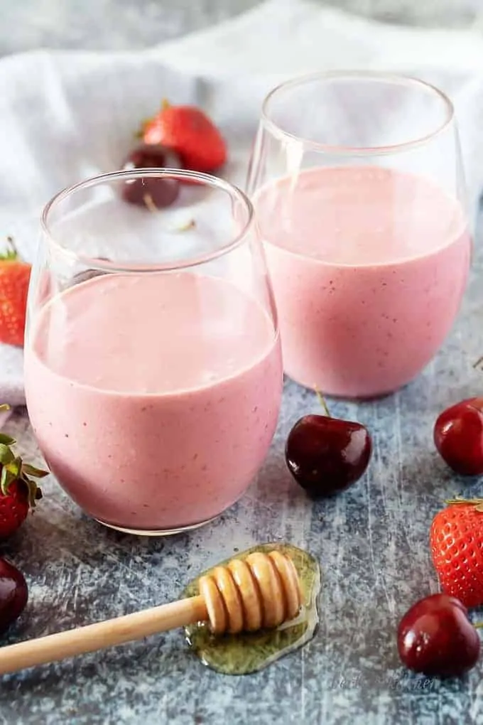 A large picture of the berry smoothies in a glasses on display.