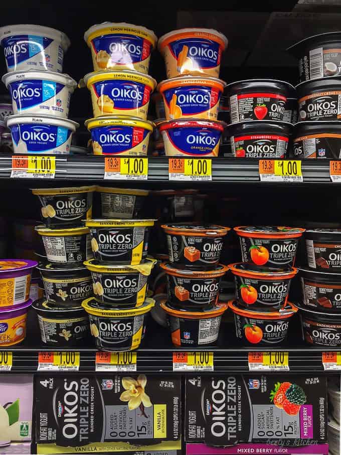 The oikos greek yogurt on this shelves at walmart highlighting the flavors available for purchase.