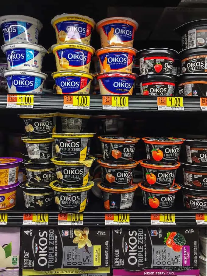 The Oikos Greek Yogurt on this shelves at Walmart highlighting the flavors available for purchase.