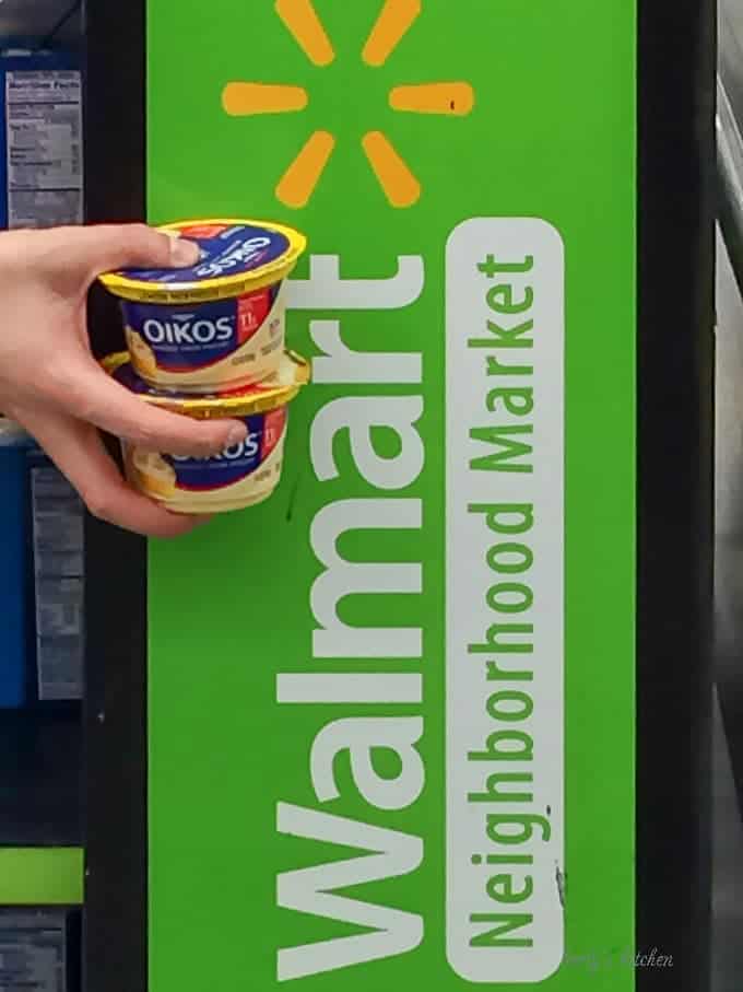 A photo showing the two of the flavors we purchased in front of a walmart branded sign.