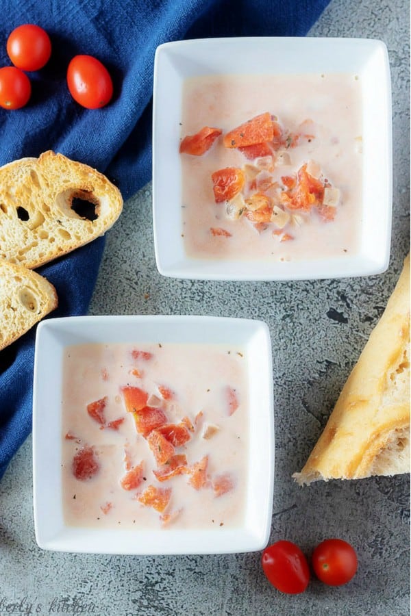 A large photo of the cream of tomato soup, served in bowls with slices of toasted sourdough bread.