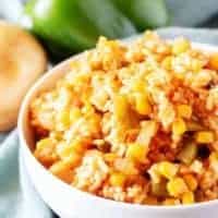 A close-up view of the finished Mexican rice in white bowl for serving.