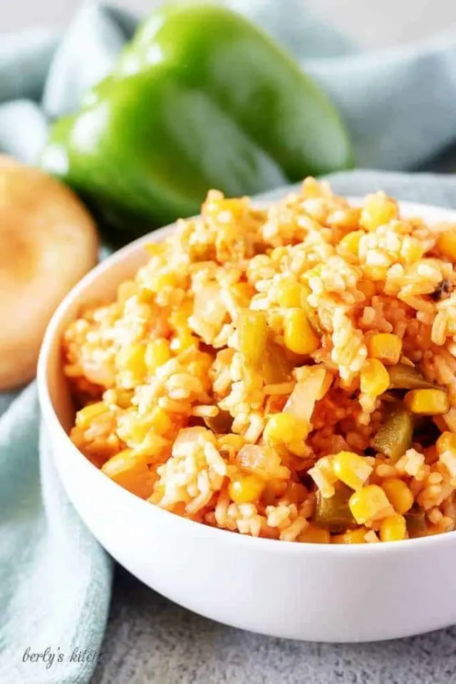A close-up view of the finished Mexican rice in white bowl for serving.