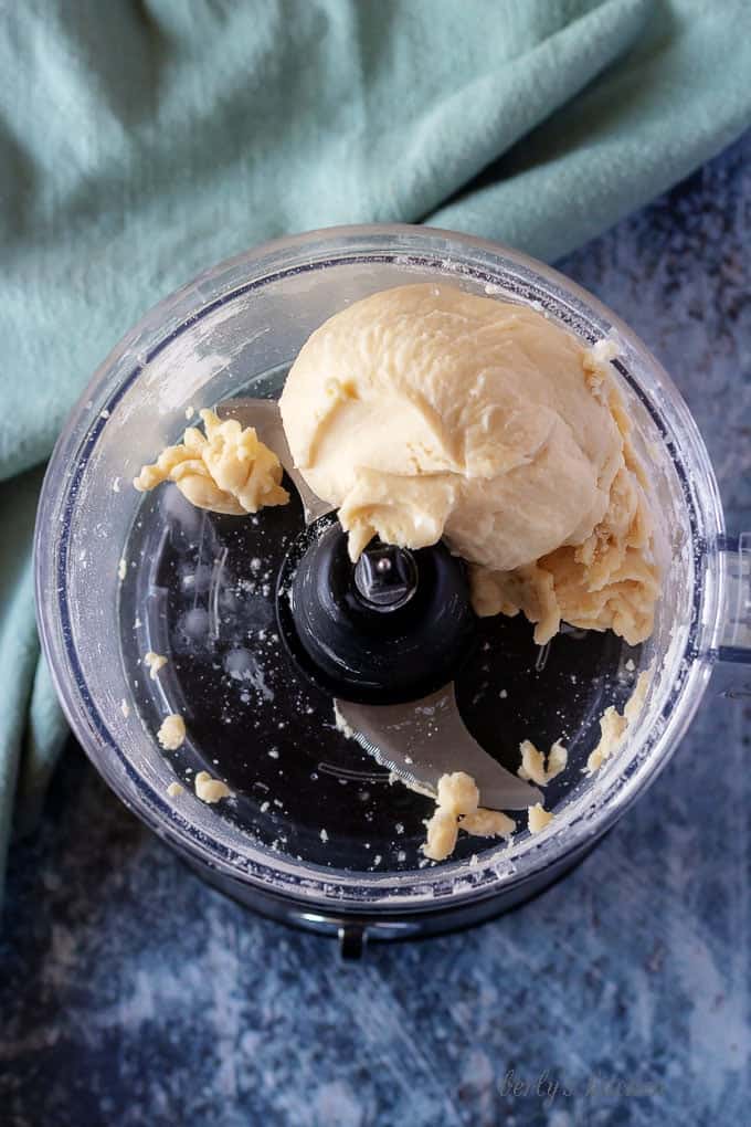 A top-down photo of the food processor with all the ingredients combined into a ball of dough.