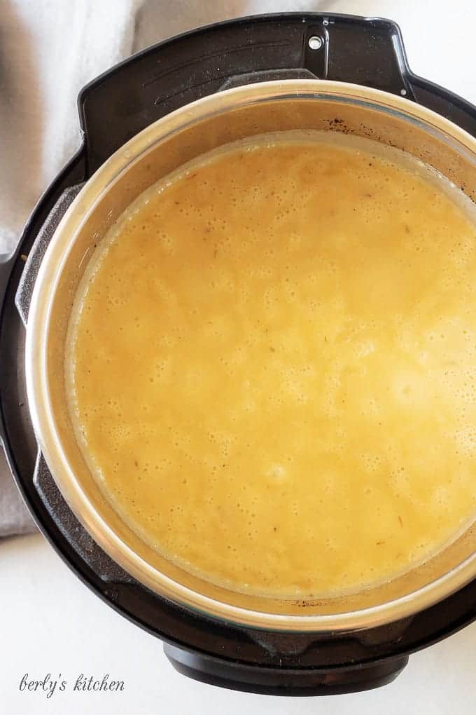 A photo, looking down into the instant pot, showing the broth and potatoes, just after cooking.